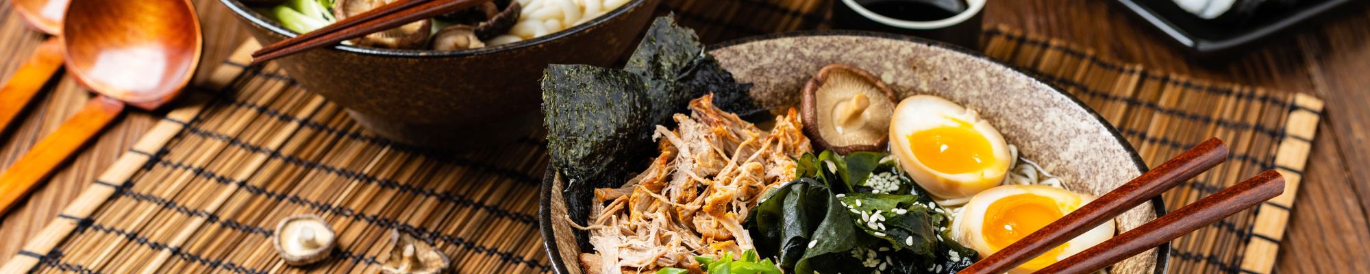 two beautiful bowls of ramen with a soft-boiled egg